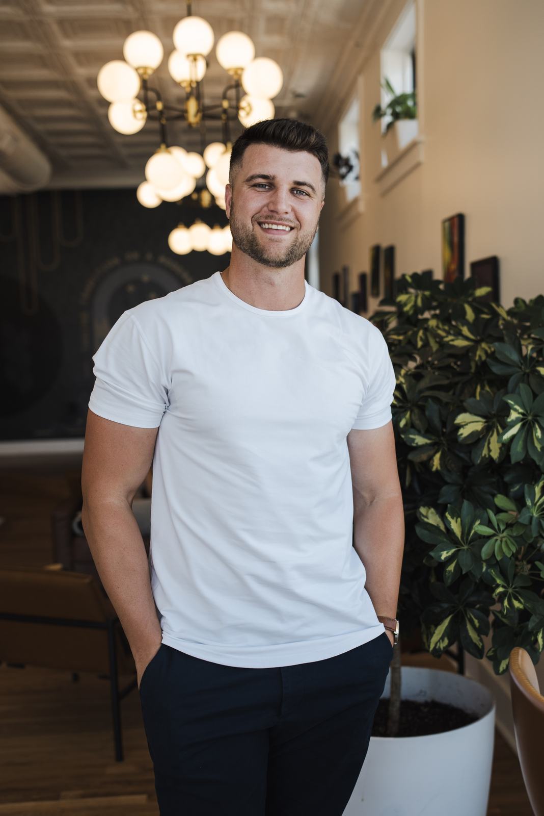 Jaden Barr smiling, standing in a bright lounge