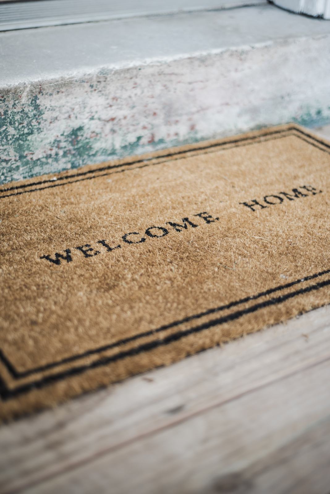 Welcome home doormat on a front step